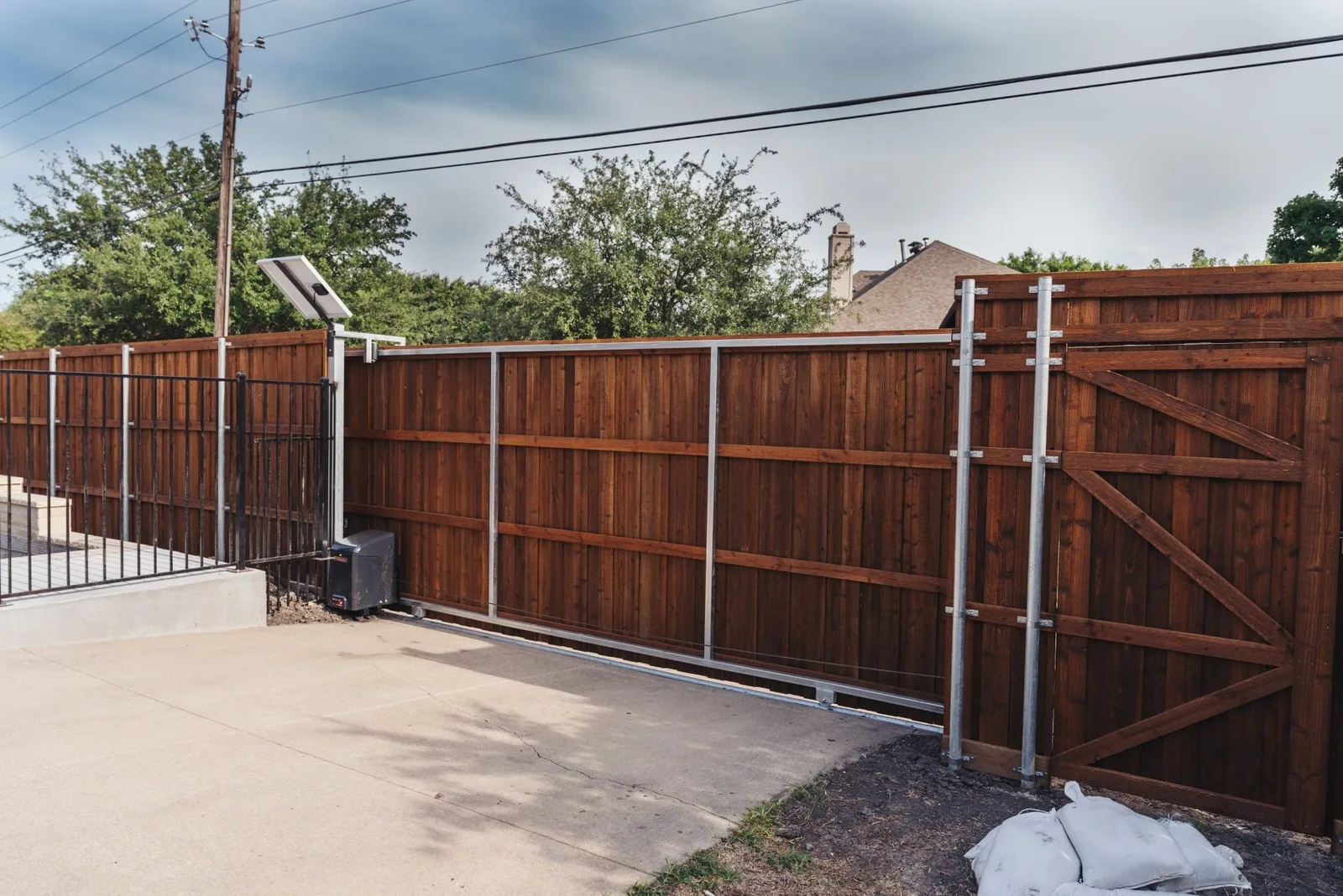 Cedar sliding driveway gate with LiftMaster opener in Pearland, TX