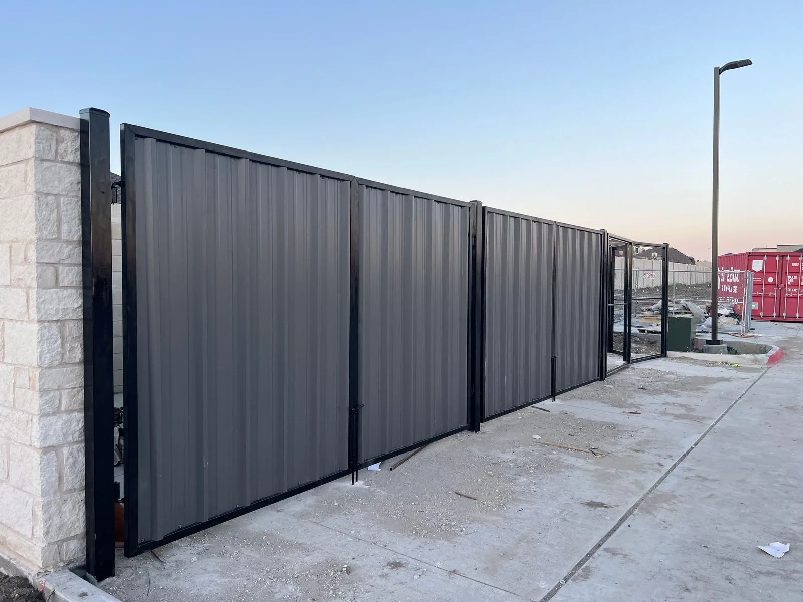 Commercial Corrugated Steel Fence, Stone Columns