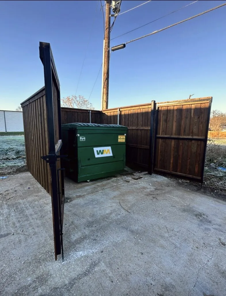 Commercial cedar and steel dumpster enclosure in Pearland, TX