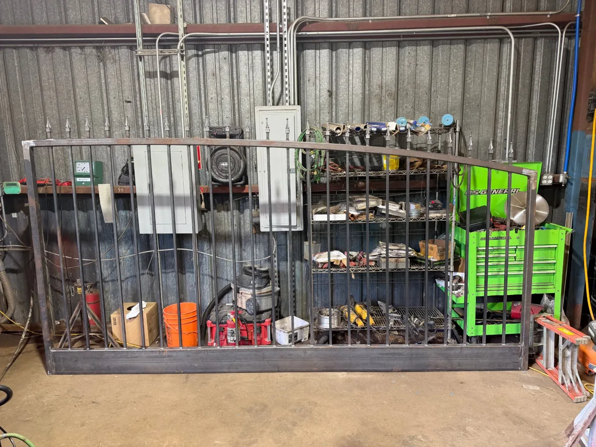 Spear-top iron driveway gate panel fabricated by our own crew before finishing — Pearland, TX