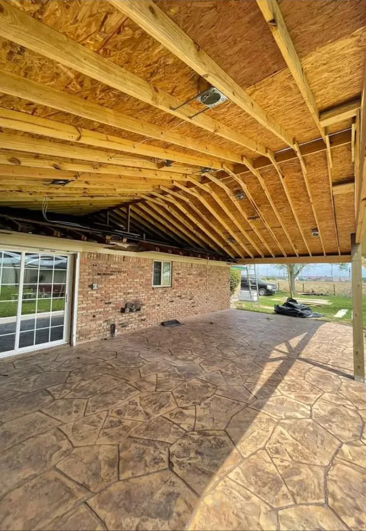 Gable patio cover framing over stamped concrete built by Forged Fence & Deck in Pearland, TX