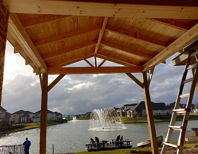 Lakeside gable patio cover with exposed rafters built by Forged Fence & Deck in Pearland, TX