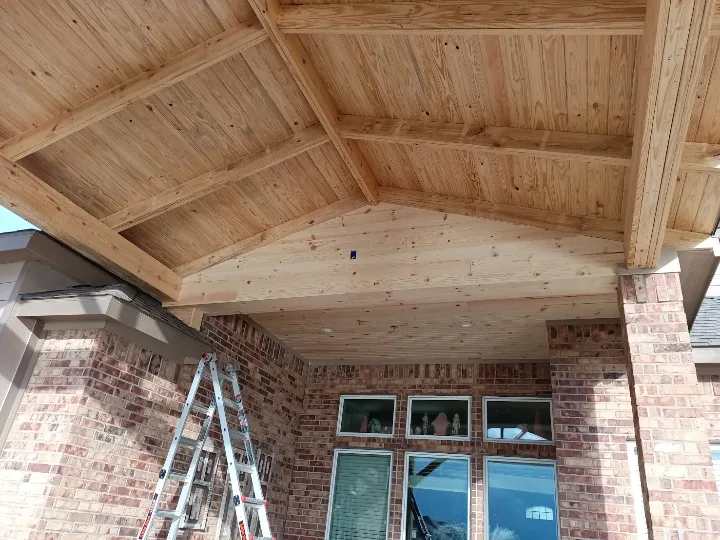 Attached gable patio cover with tongue-and-groove wood ceiling built by Forged Fence & Deck in Pearland, TX