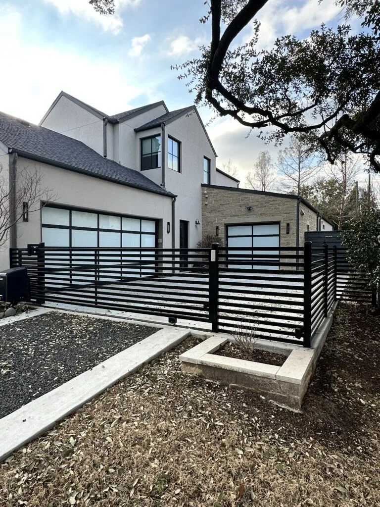 Modern horizontal black steel ranch-rail fence in Pearland, TX