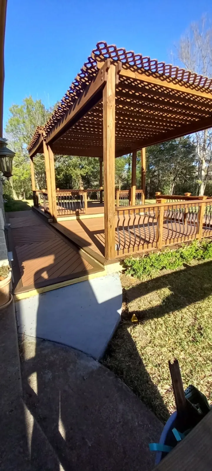 Lattice-top cedar pergola over a stained deck built by Forged Fence & Deck in Pearland, TX