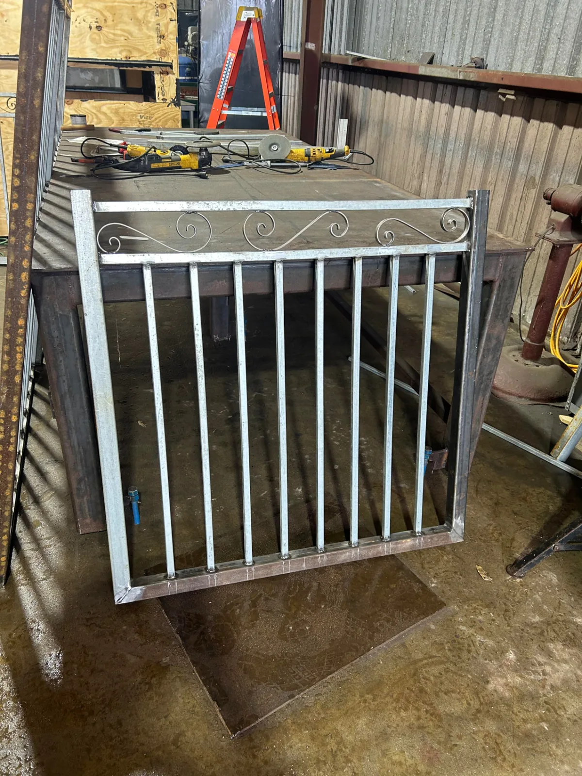 Galvanized walk gate with hand-formed ornamental scrollwork detail — custom welded in Pearland, TX