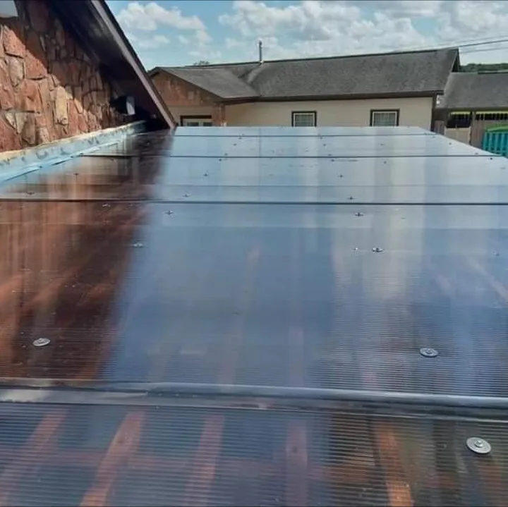 Polycarbonate roof panels installed over a cedar patio cover by Forged Fence & Deck in Pearland, TX